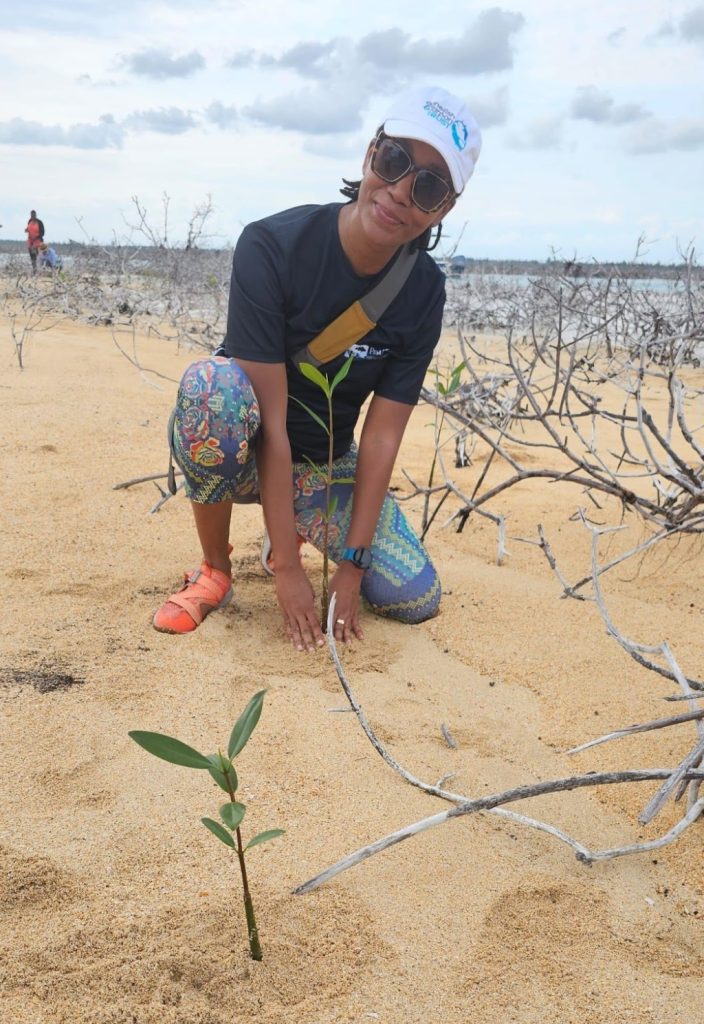 Dr. Karlisa Callwood planting mangrove seedlings in Grand Bahama