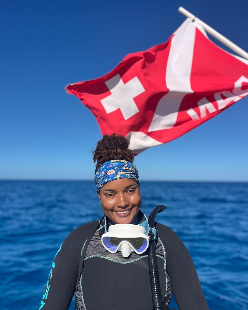 Taylor turned early diving challenges into leadership, now managing coral microfragment projects and inspiring others to dive in.