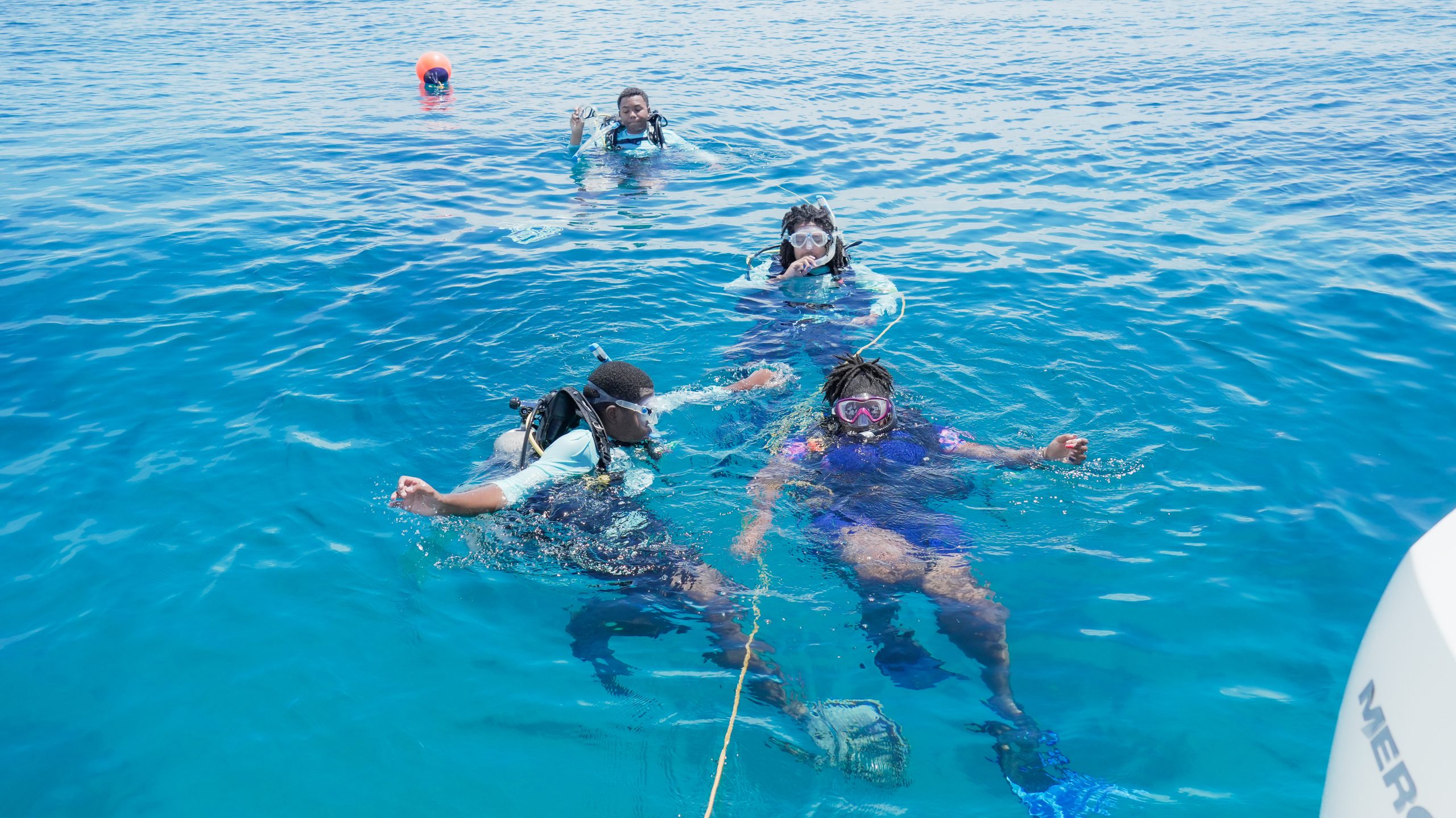 Training divers check in at the surface during a Nassau coral restoration session.